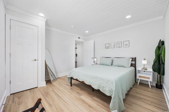 Bedroom featuring recessed lighting, light wood-style floors, baseboards, and crown molding | Image 21