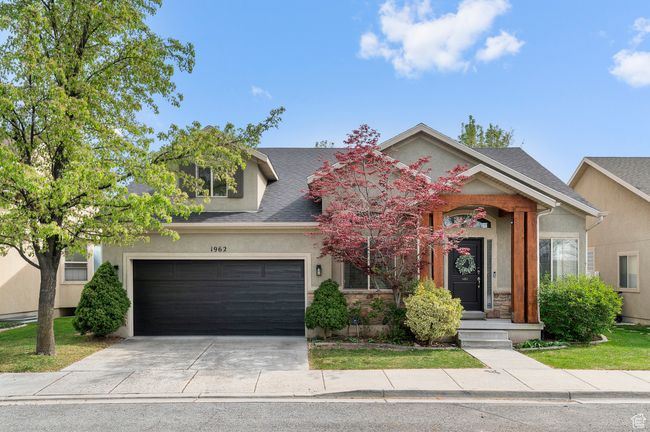View of front facade featuring a garage, a shingled roof, driveway, and stucco siding | Image 28