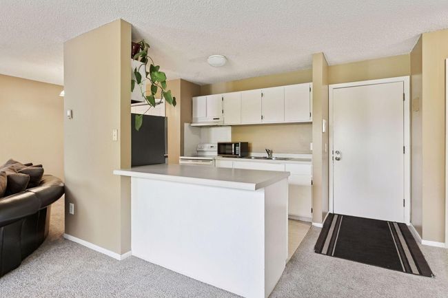 Breakfast bar for easy dinner nights! You'll love the open kitchen to living room design. | Image 8
