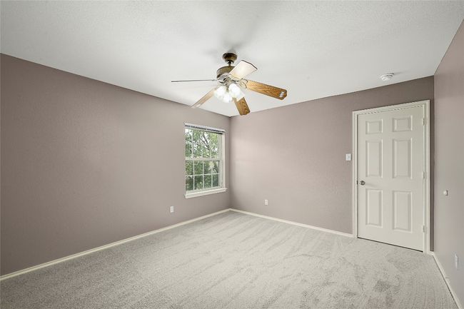Carpeted empty room with a ceiling fan and a smoke detector | Image 26
