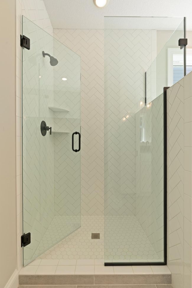 Owner's bathroom tiled shower. Photos may not depict actual home plan configuration. Features/materials/finishes shown contain options that are not included in price. | Image 14