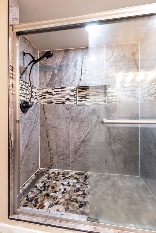 Another view of first bathroom. Gorgeous tiled shower on main level | Image 21