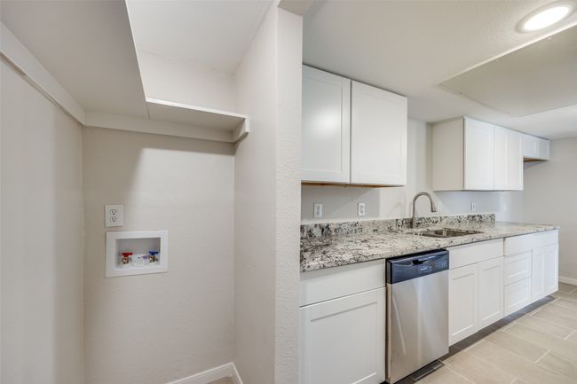 Kitchen with dishwasher, white cabinets, and sink | Image 11