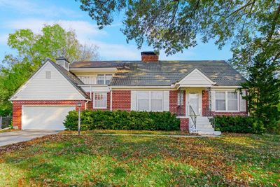 View of front facade with a garage and a front yard | Image 1