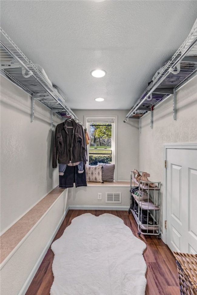 Owners additional walk in closet with small door to very large storage space. | Image 17
