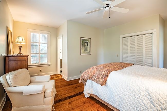 Bedroom featuring ceiling fan, a closet, and dark hardwood / wood-style flooring | Image 29