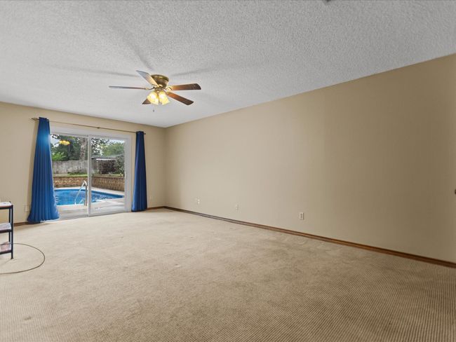 Master Bedroom Carpeted empty room with a ceiling fan, baseboards, and a textured ceiling | Image 23