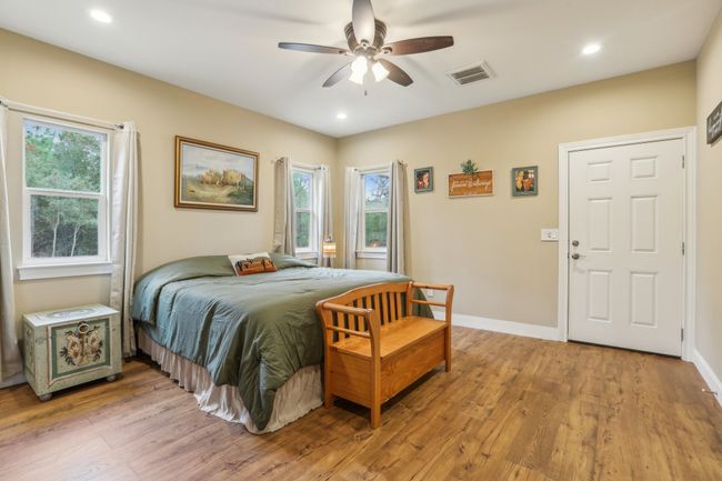 Bedroom with multiple windows, ceiling fan, and light hardwood / wood-style flooring | Image 26