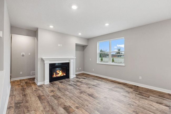 Spacious living room with electric fireplace (not shown). Model photo. Options and colors will vary. | Image 13