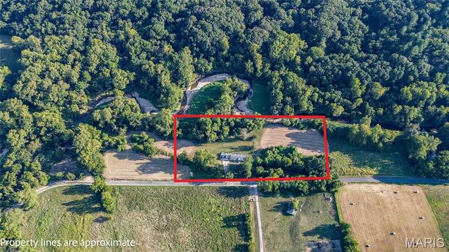 Aerial view of property's location featuring property boundaries highlighted and a heavily wooded area | Image 38