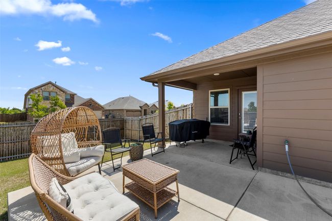 View of patio with an outdoor living space, a fenced backyard, and a grill | Image 5