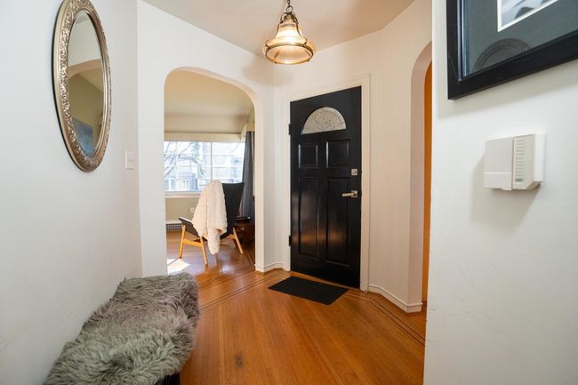 Entrance foyer featuring light wood finished floors, arched walkways, and baseboards | Image 20