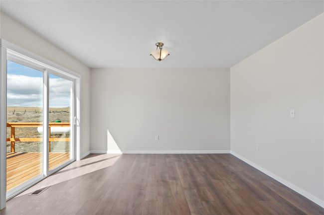 Unfurnished room with baseboards, dark wood-style floors, and visible vents | Image 39