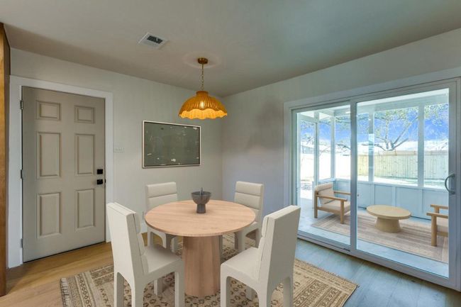 Dining room with visible vents and light wood finished floors | Image 4
