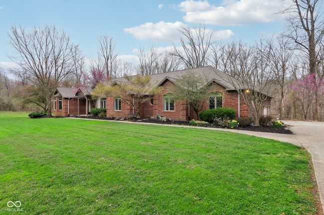single story home featuring brick siding, concrete driveway, and a front lawn | Image 4