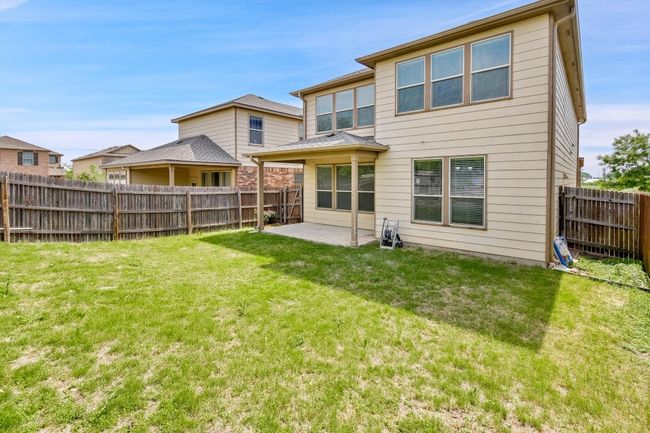 Back of property with a fenced backyard, a yard, and a patio | Image 30