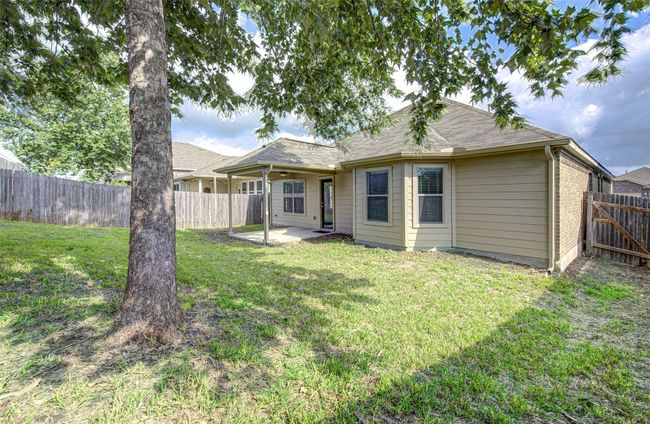Back of house with a patio, a fenced backyard, and a shingled roof | Image 28