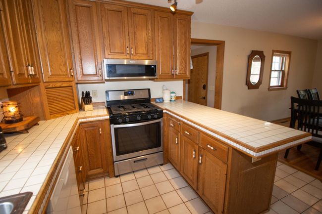 Lots of cabinets and stainless appliances. | Image 7