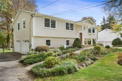 Split foyer home featuring a garage | Image 2