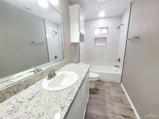 Bathroom featuring vanity and bathing tub / shower combination | Image 19