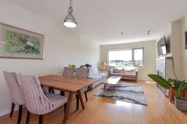 Dining space with light wood-style flooring and a tiled fireplace | Image 5
