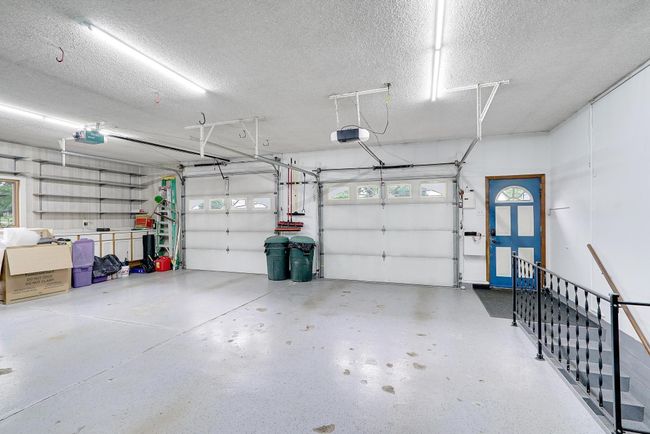 A garage lover's dream! Taller garage door to accomodate larger vehicles, this garage is attached and has epoxy flooring. Plus convenient access directly to lower level. | Image 36