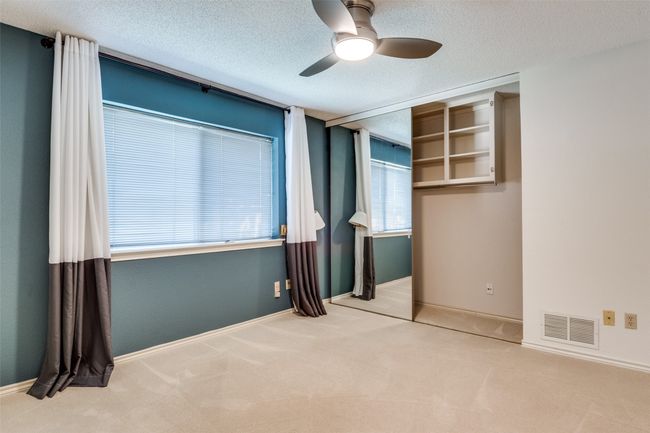 Unfurnished bedroom featuring carpet, a textured ceiling, and ceiling fan | Image 18