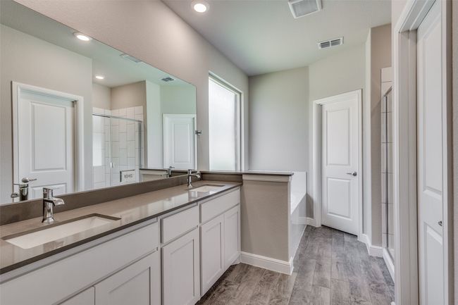 Bathroom featuring hardwood / wood-style flooring, dual vanity, and separate shower and tub | Image 20