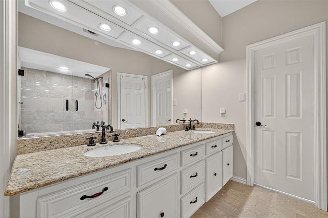 A long dual-sink vanity provides symmetry and storage, while ambient lighting and custom finishes give the room an elevated feel—an inviting start or finish to your day. | Image 40