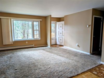 Carpeted empty room with baseboard heating | Image 2