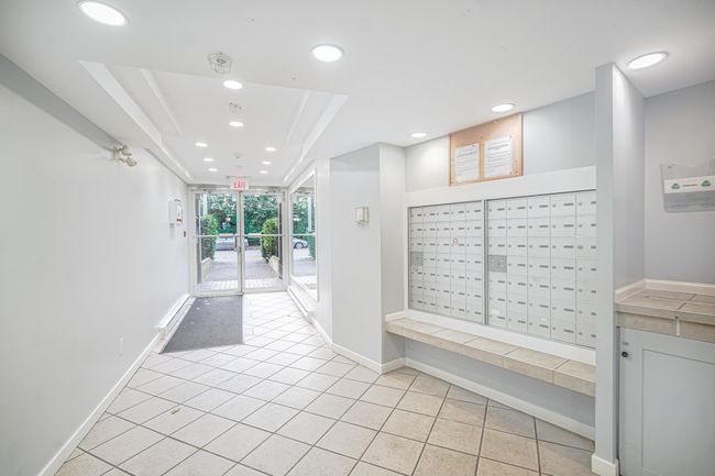 Interior space featuring baseboards, mail area, light tile patterned flooring, and recessed lighting | Image 14