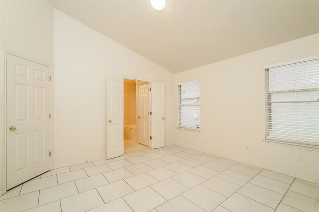 Unfurnished room featuring lofted ceiling and light tile patterned floors | Image 12