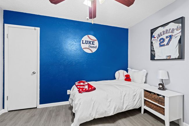 2nd Bedroom featuring a ceiling fan, a textured ceiling, baseboards, and wood finished floors | Image 16
