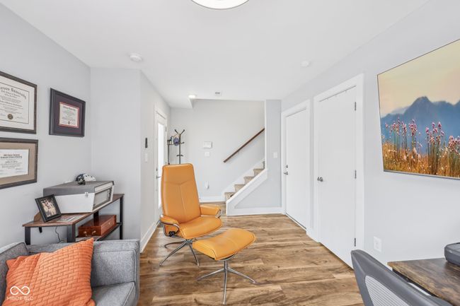 living area with baseboards, stairs, and wood finished floors | Image 11