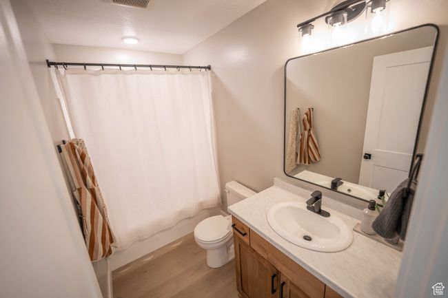 The main bath carries the modern aesthetic from the rest of the home, featuring warm cabinetry and sleek, up-to-date finishes that tie the whole look together beautifully. | Image 23