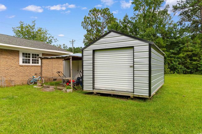 View of green lawn featuring an outdoor structure and an outbuilding | Image 27