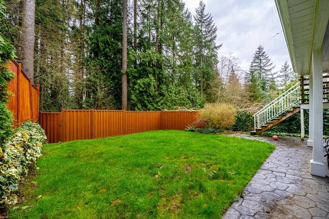 View of yard featuring a fenced backyard and stairway | Image 38