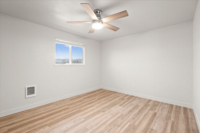 Unfurnished room with light wood-style floors, ceiling fan, and heating unit | Image 16