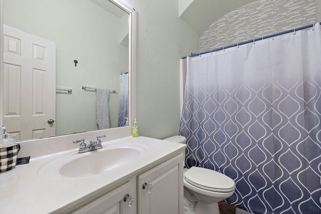 Upstairs guest full bath featuring vanity and toilet | Image 27