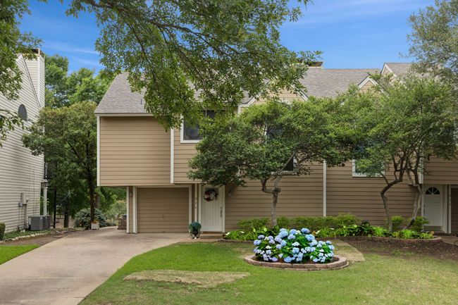 View of front of house featuring concrete driveway, a shingled roof, central air condition unit, a front lawn, and a garage | Image 26