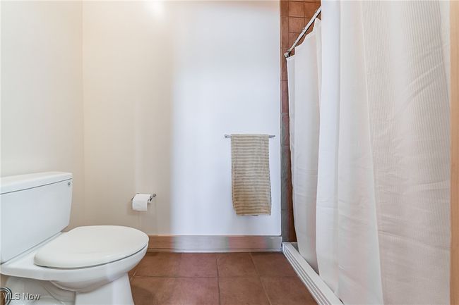 Full bath featuring tile floors and a walk-in shower. | Image 25