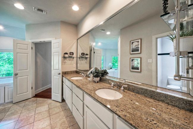 Primary bathroom featuring dual sinks and granite counter... tons of counter space! | Image 23