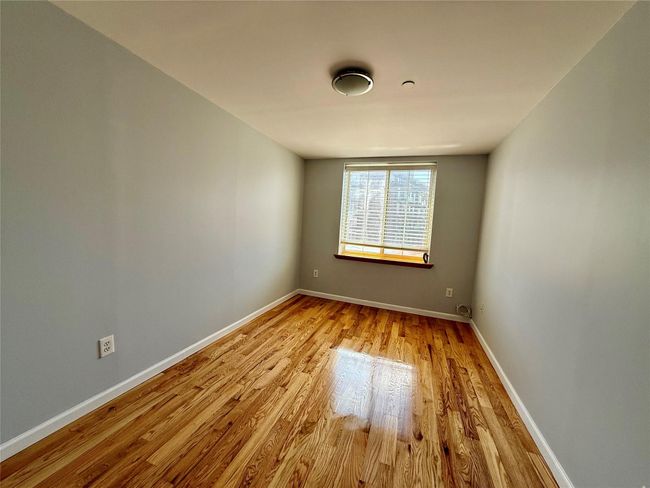 Spare room with wood finished floors and baseboards | Image 6