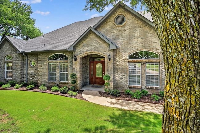 View of front of house featuring brick siding, roof with shingles, and a front yard | Image 4