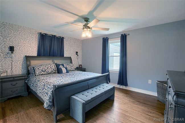 Bedroom with ceiling fan and dark wood-type flooring | Image 41