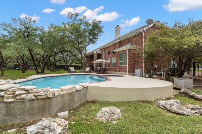 Outdoor pool with a patio area and a lawn | Image 38