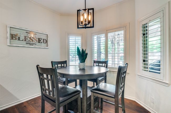 inviting chandelier, bay window, plantation shutters | Image 15
