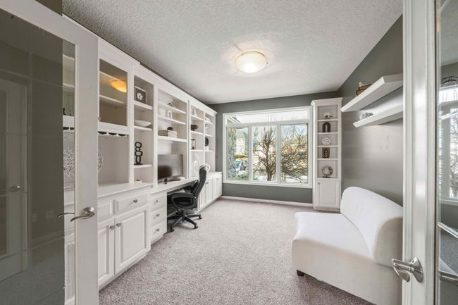 Beautiful office with a wall of shelves with a desk | Image 4