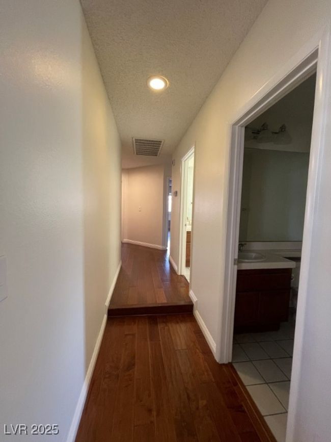 Hallway featuring hardwood / wood-style flooring, a textured ceiling, and recessed lighting | Image 14