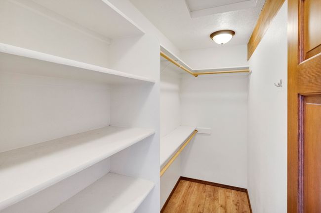 Spacious closet featuring light wood-type flooring | Image 35